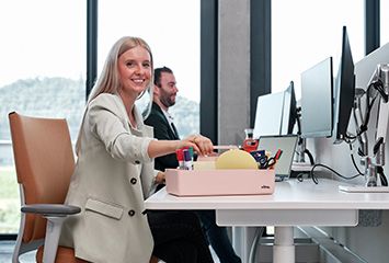 Mitarbeiter arbeiten am Schreibtisch und benutzen Bürobedarfsartikel