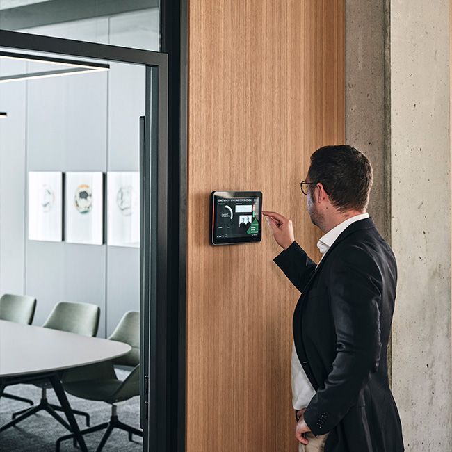 Mann bedient Room Panel für Raumbuchung