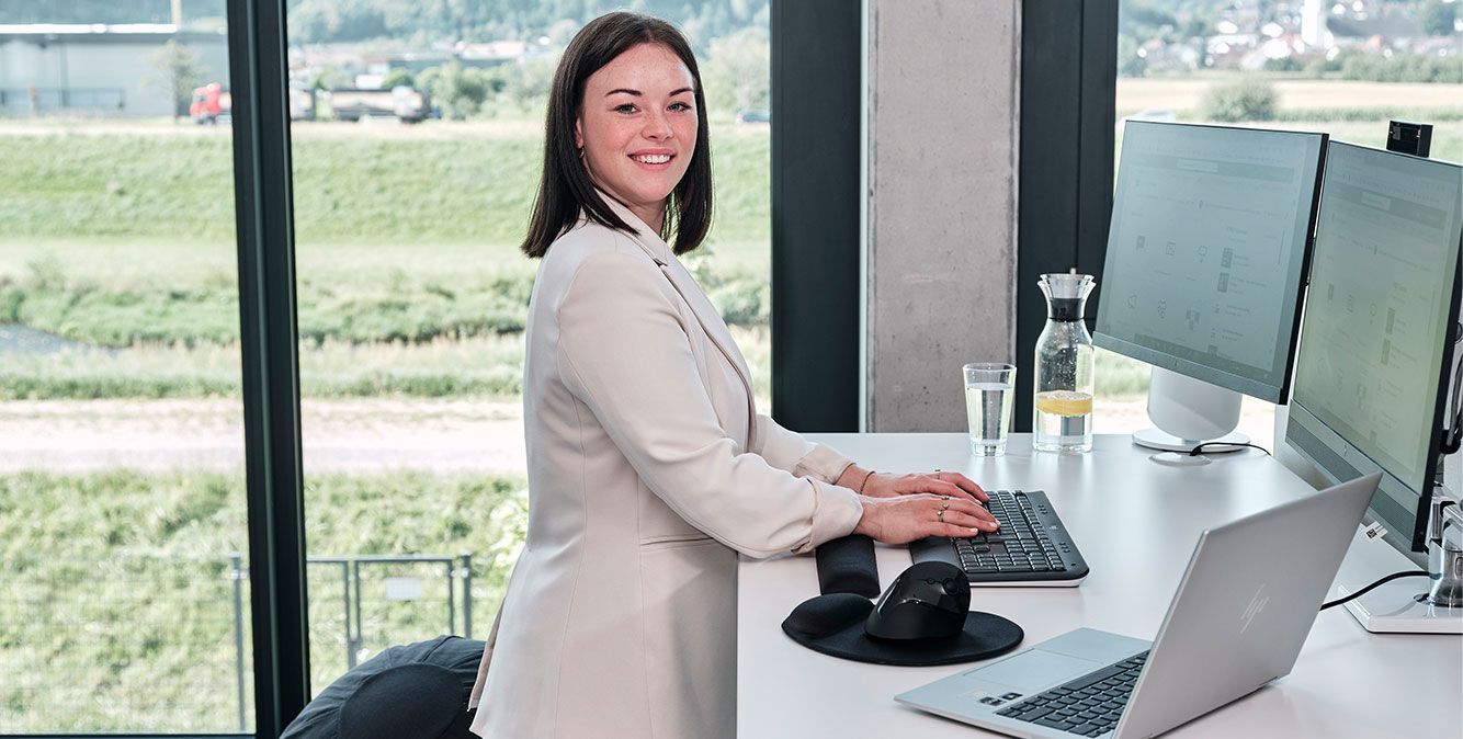 Mitarbeiterin von Streit Service & Solution arbeitet an ihrem Schreibtisch am PC