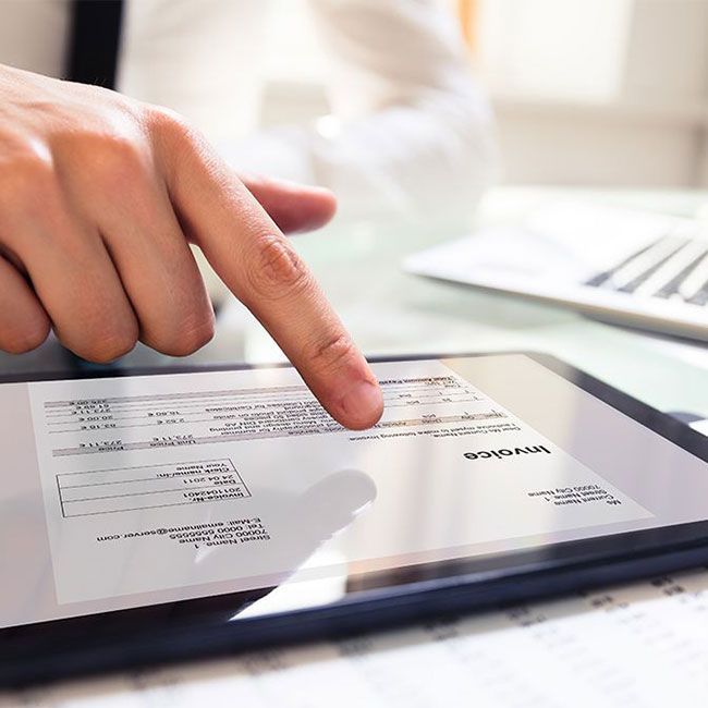 Eine Hand bedient ein Tablet mit einer digitalen Rechnung