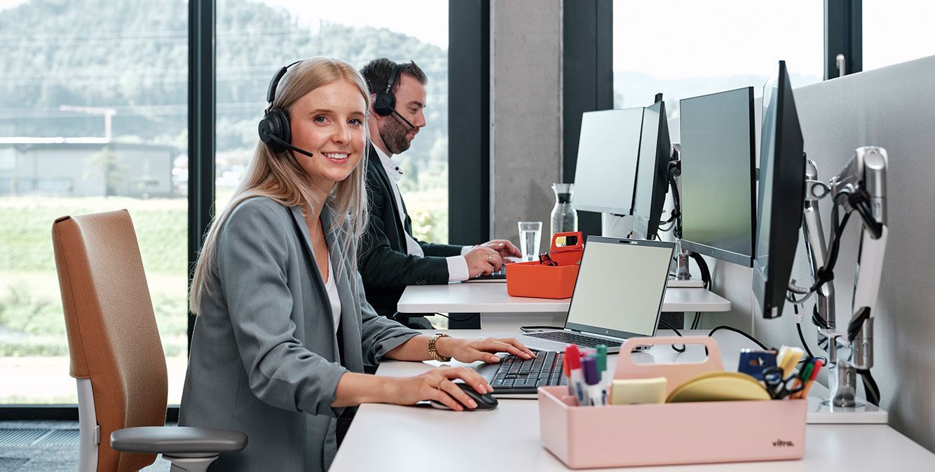 Kundenservice Mitarbeiter von Streit Service & Solution sitzt am Schreibtisch und telefoniert mit Headset